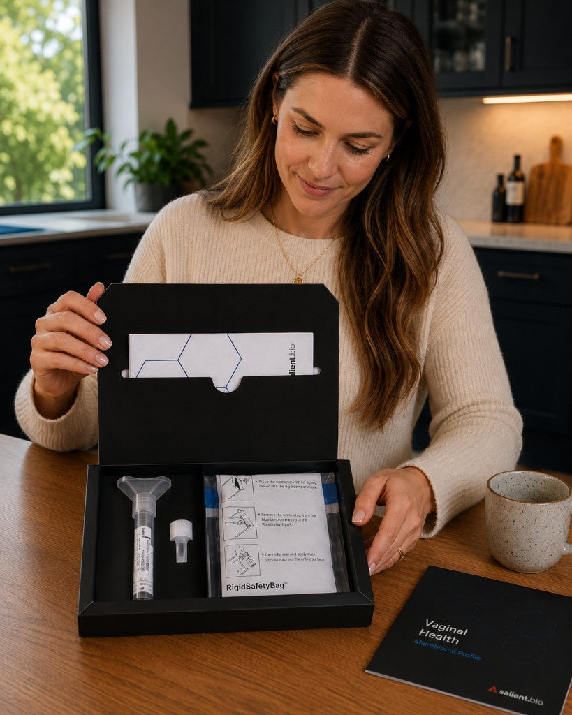 Person opening a Vaginal Health Microbiome Profile kit and reviewing collection instructions at home
